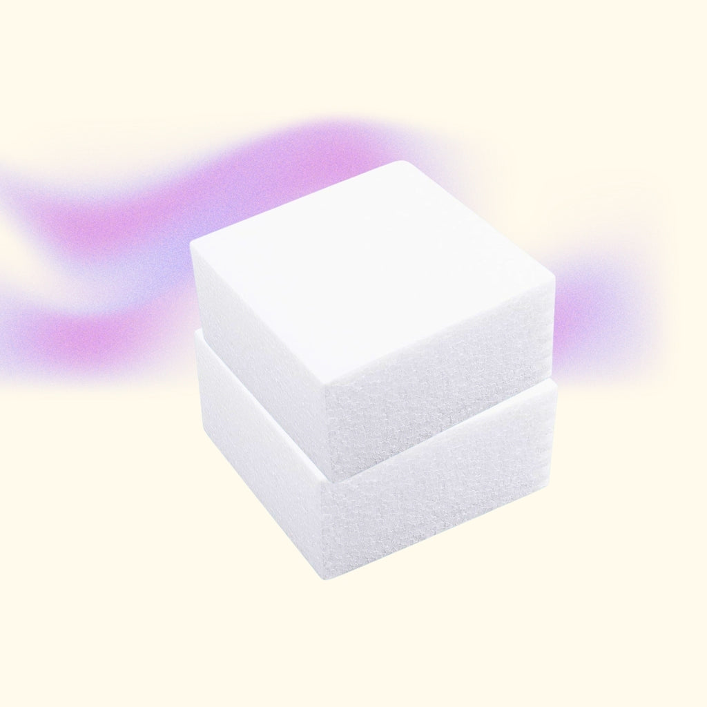 Two styrofoam cubes are set against a pink and cream background.