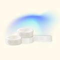 Rolls of adhesive glue dots are seen against a blue and cream background.